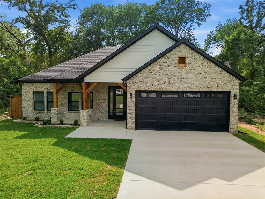 429 Waterboard Road Trinidad, TX 75163 - Photo 1 of 25 Contemporary home exterior featuring light-colored brick, a dark asphalt shingle roof, and black-framed windows