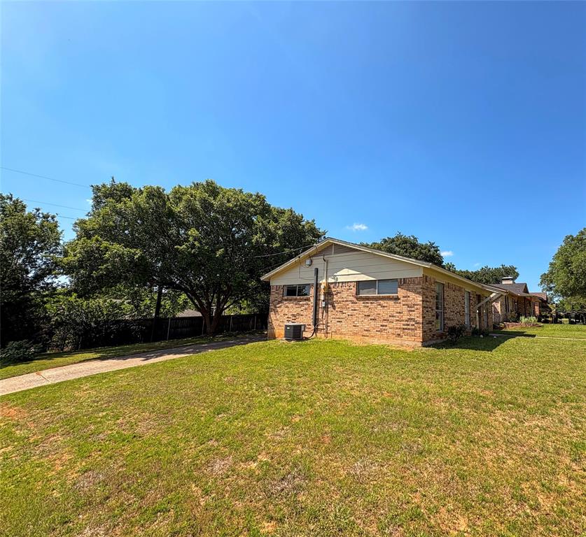 1829 South Center Street Denison, TX 75021 - Photo 4 of 29 a view of a house with a yard and a large tree