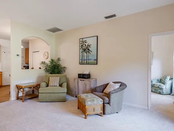 a living room with furniture and a potted plant