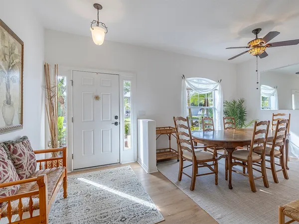 a view of a dining room with furniture and chandelier