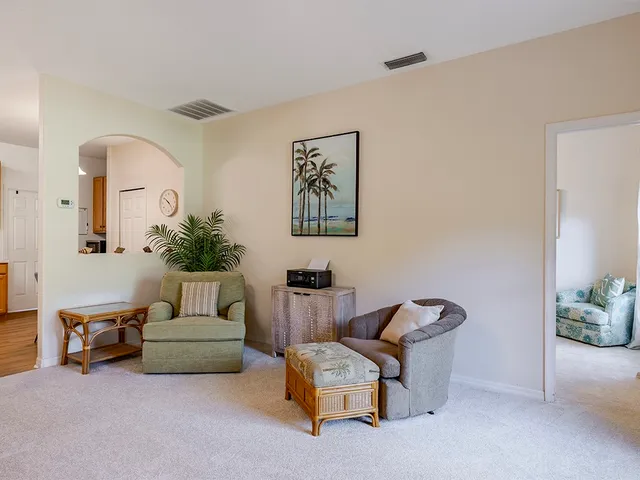 a living room with furniture and a potted plant