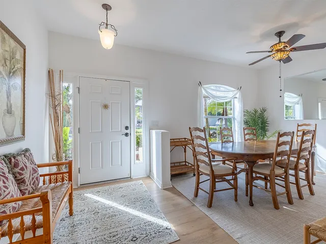 a view of a dining room with furniture and chandelier