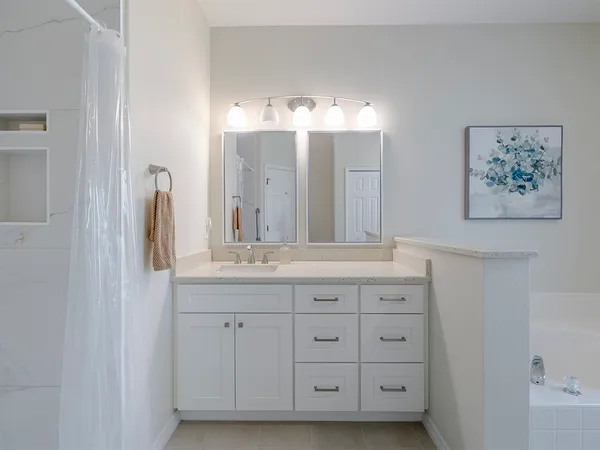 a bathroom with a double vanity sink and a mirror