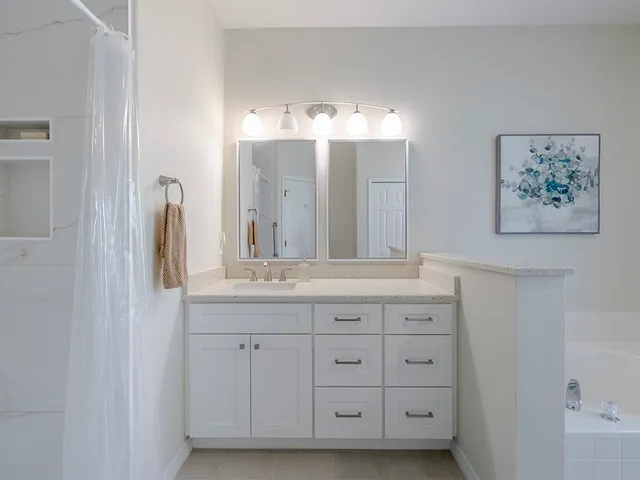 a bathroom with a double vanity sink and a mirror