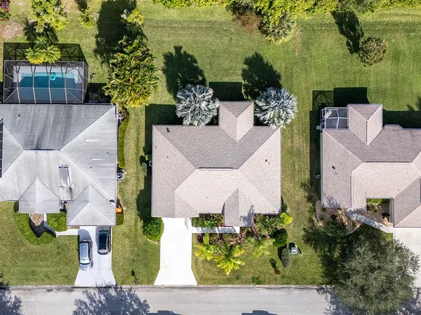 an aerial view of a house with a garden and yard