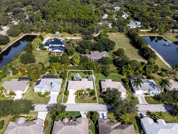 an aerial view of residential houses with outdoor space
