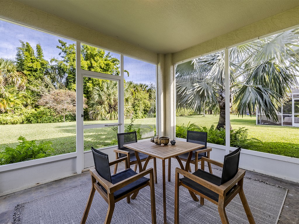 3648 2nd Street Southwest Vero Beach, FL 32968 - Photo 5 of 36 a view of a patio with a table chairs and a yard