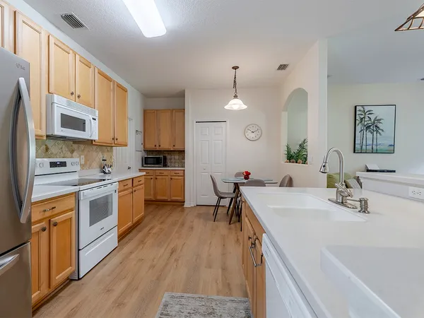 a kitchen with a sink stove and cabinets