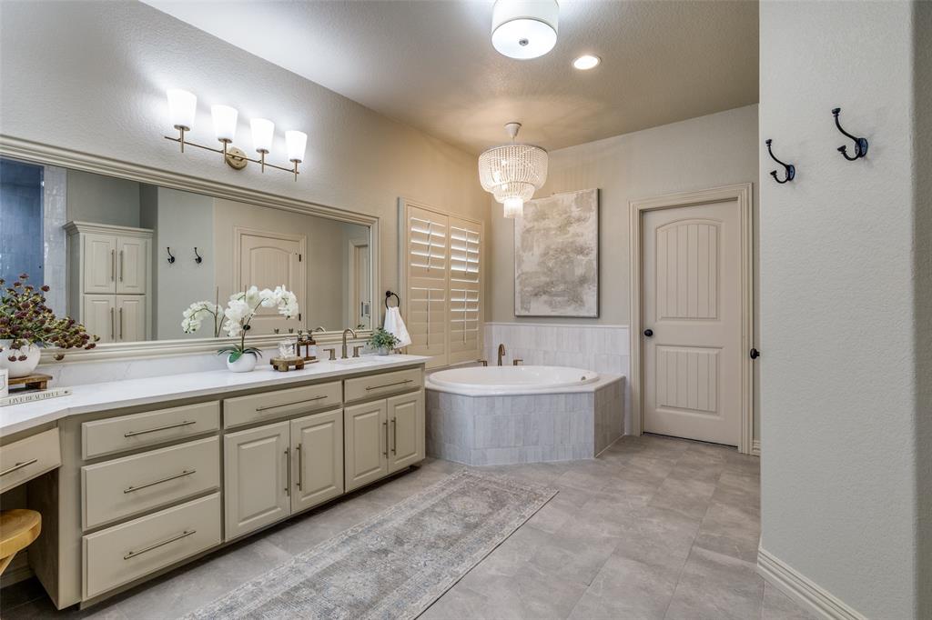 1150 Lone Star Road Bowie, TX 76230 - Photo 22 of 38 a spacious bathroom with a double vanity sink mirror and bathtub