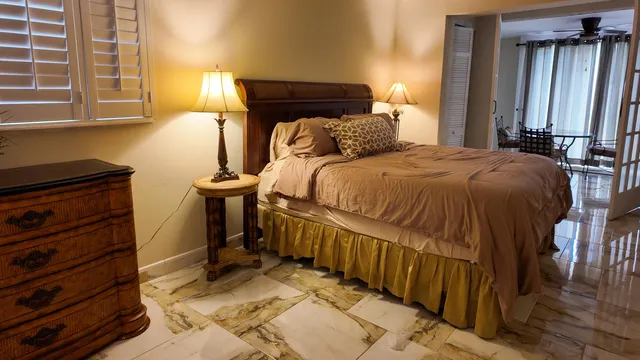 a bedroom with a bed and a window