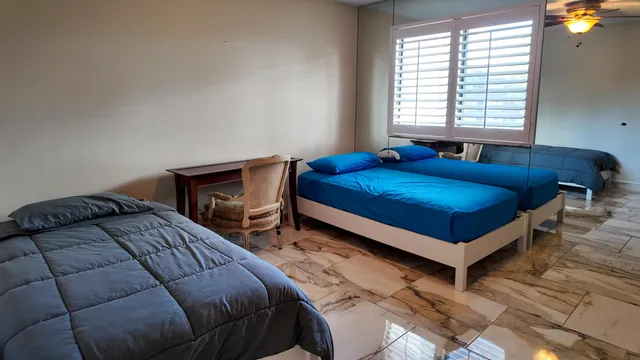 a bedroom with a bed and a window