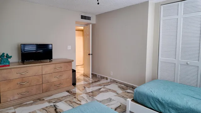 a bedroom with a bed and a flat screen tv