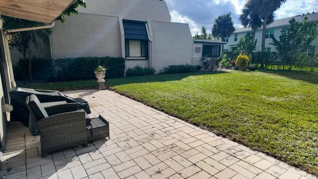 a view of backyard with patio