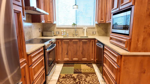 a view of a kitchen with a sink and cabinets