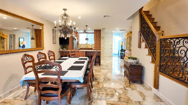 a view of a dining room with furniture and a chandelier