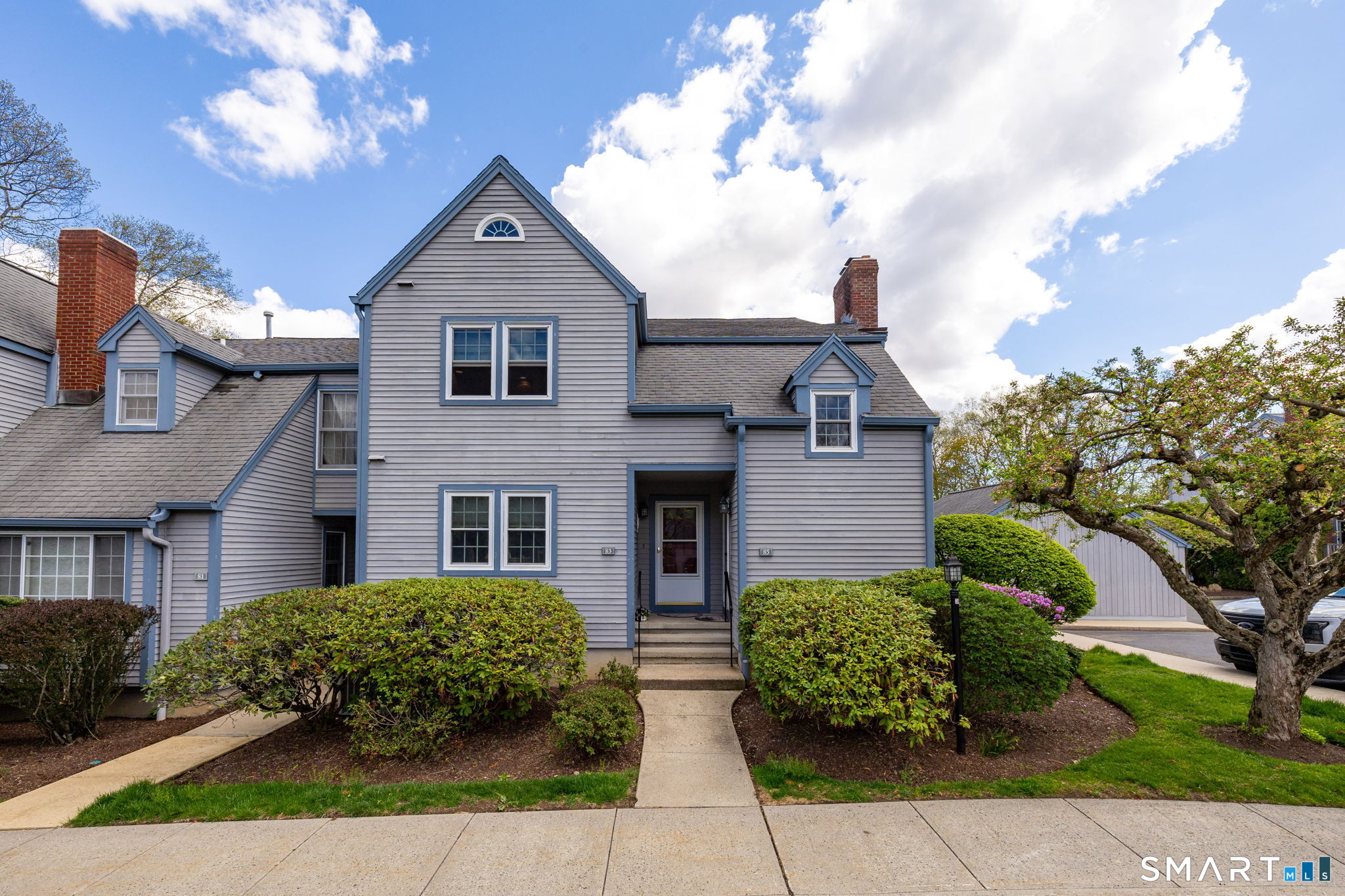 a front view of a house with garden