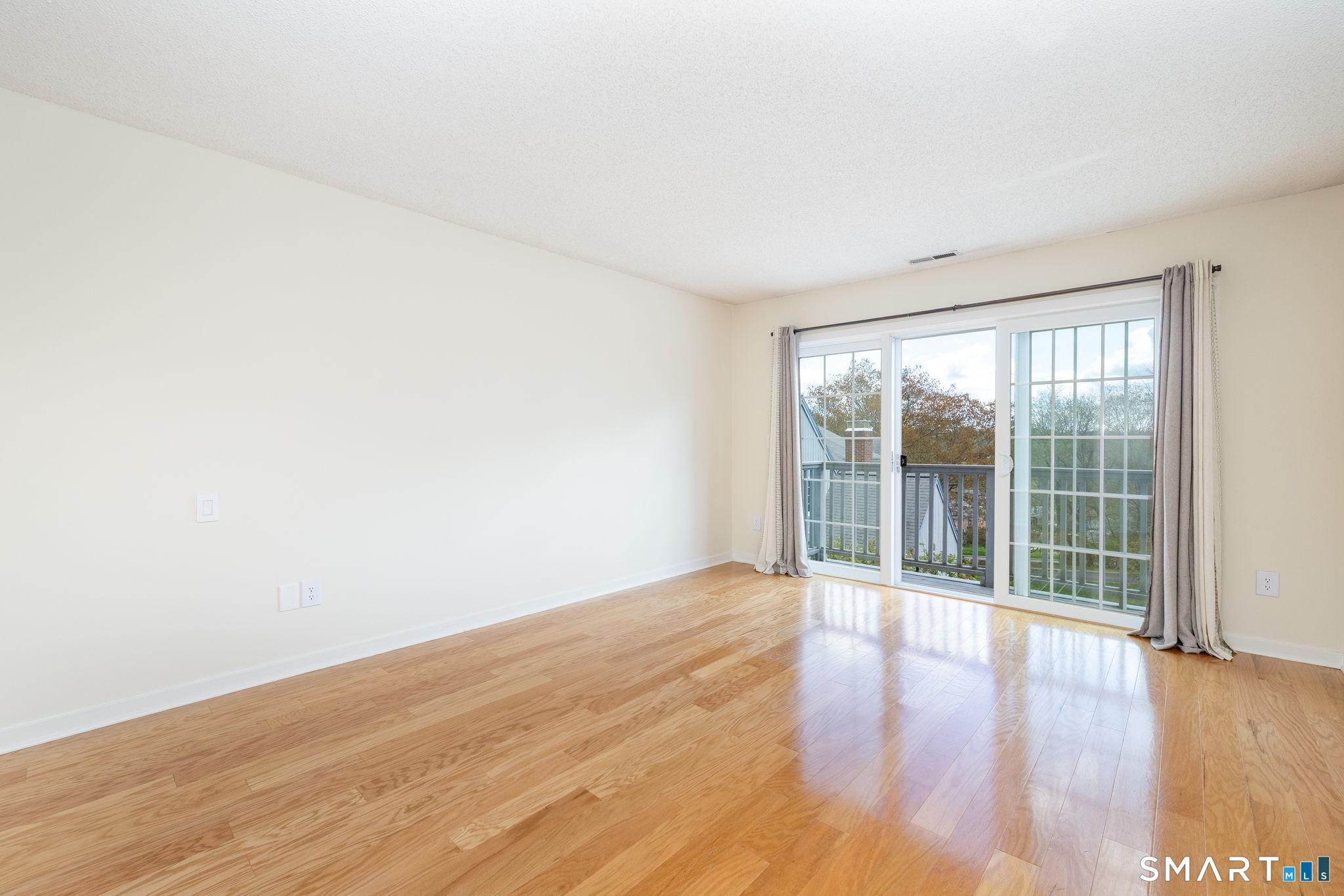 85 Gate Ridge Road, Unit 85 Fairfield, CT 06825 - Photo 13 of 38 wooden floor in an empty room with a window