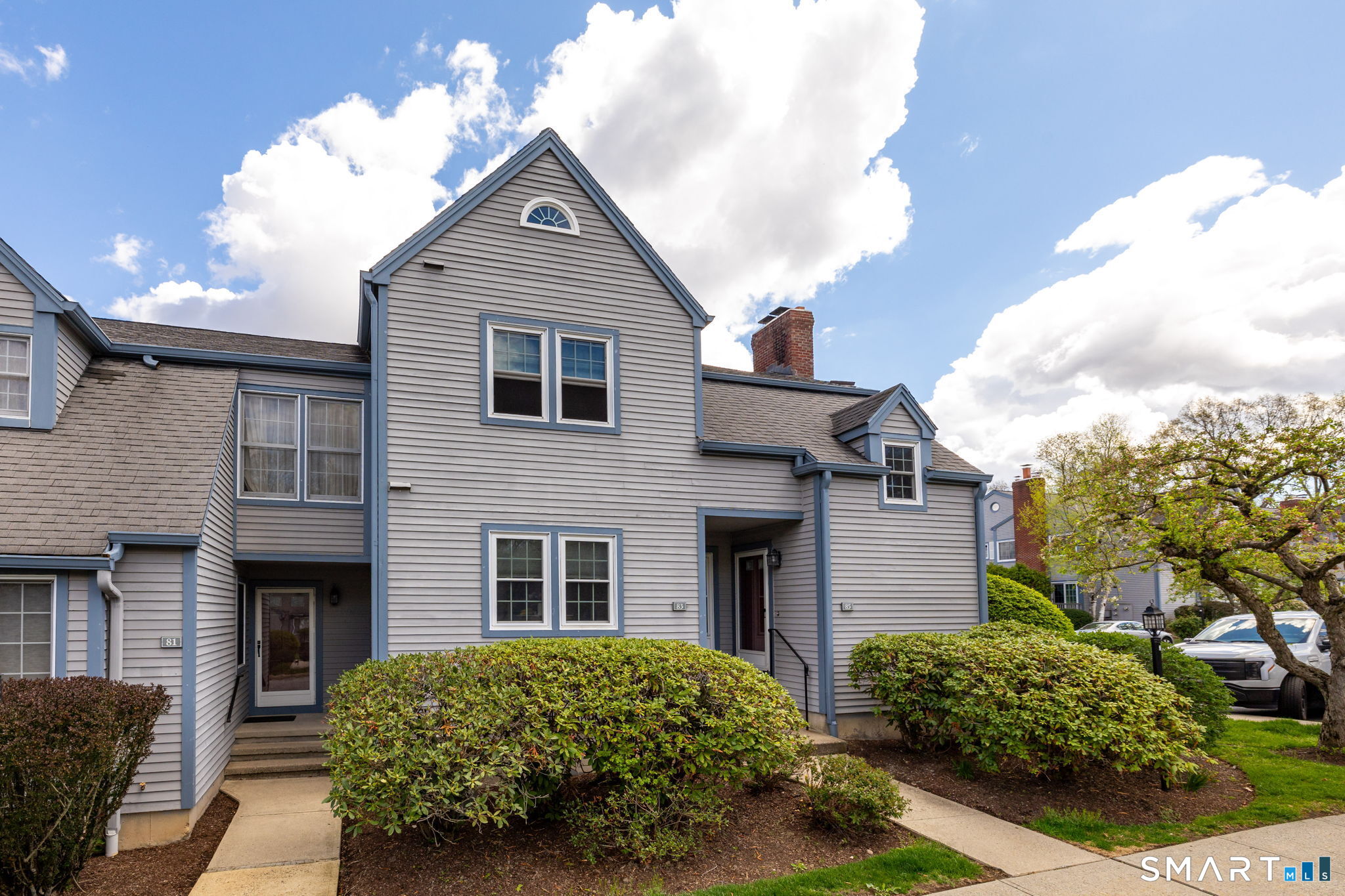 85 Gate Ridge Road, Unit 85 Fairfield, CT 06825 - Photo 31 of 38 a front view of a house with a garden
