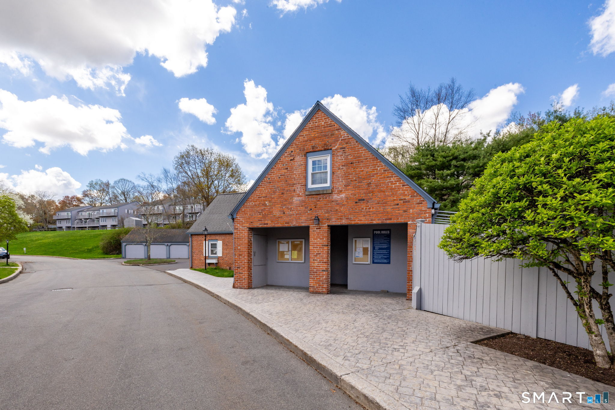 85 Gate Ridge Road, Unit 85 Fairfield, CT 06825 - Photo 34 of 38 a front view of a house with a yard and a garage