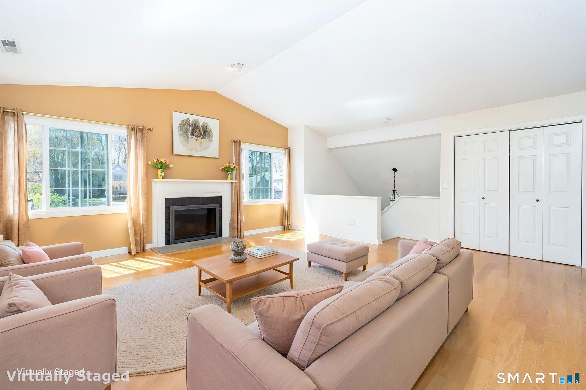 85 Gate Ridge Road, Unit 85 Fairfield, CT 06825 - Photo 4 of 38 a living room with furniture a fireplace and a large window