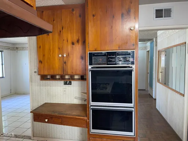 a kitchen with wooden cabinets and a sink