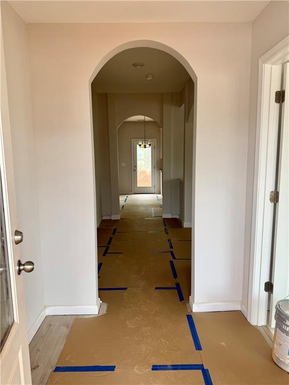 501 Charleston Place Villa Rica, GA 30180 - Photo 2 of 18 a view of a hallway with wooden floor and a living room