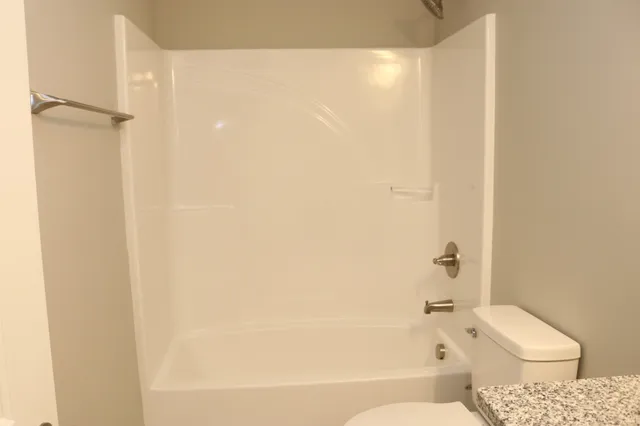 a bathroom with a bathtub and a toilet