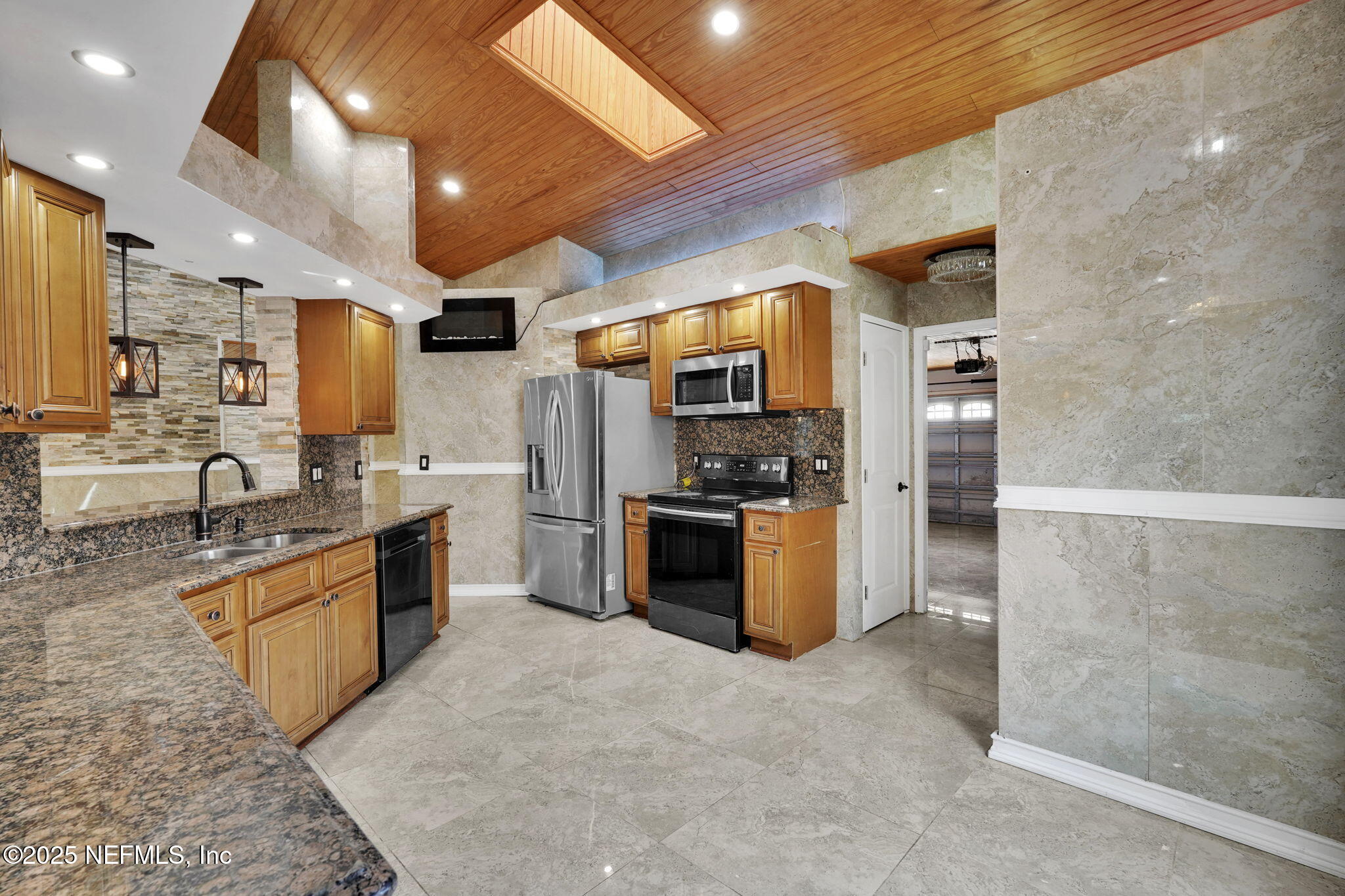 8786 Spring Harvest Lane East Jacksonville, FL 32244 - Photo 14 of 39 a large kitchen with stainless steel appliances kitchen island a large counter top a stove a refrigerator and a sink