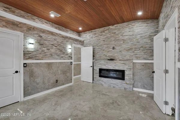 a view of an empty room with a fireplace