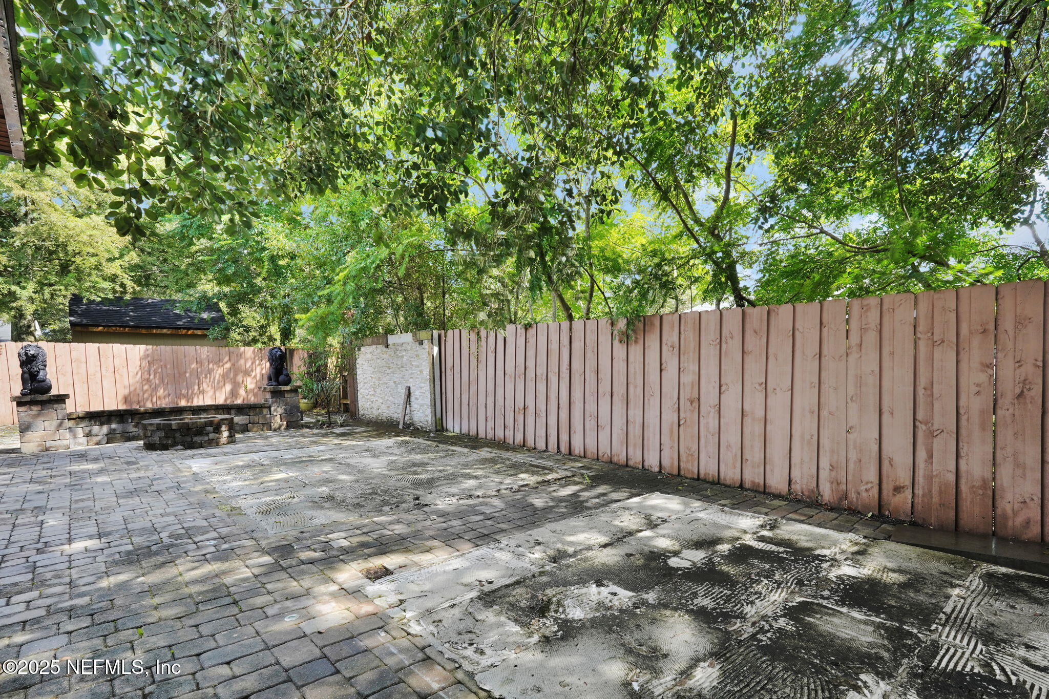 8786 Spring Harvest Lane East Jacksonville, FL 32244 - Photo 36 of 39 a view of a backyard with a trees and wooden fence
