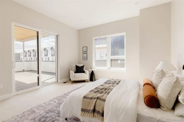 a bedroom with a bed and a large window