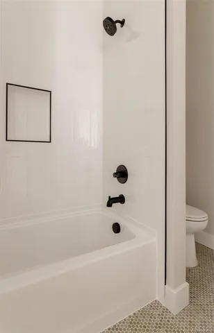 a bathroom with a bathtub and a toilet
