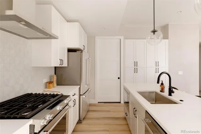 a kitchen with stainless steel appliances a sink and a stove