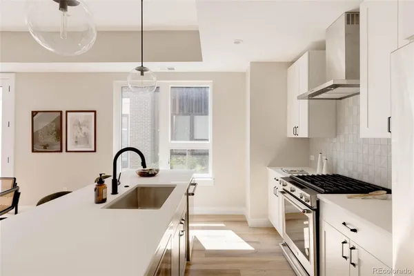 a kitchen with a refrigerator and a stove top oven