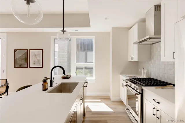 a kitchen with a refrigerator and a stove top oven