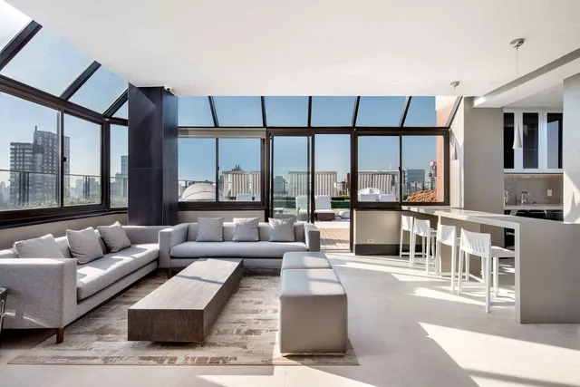 a living room with furniture and a large window