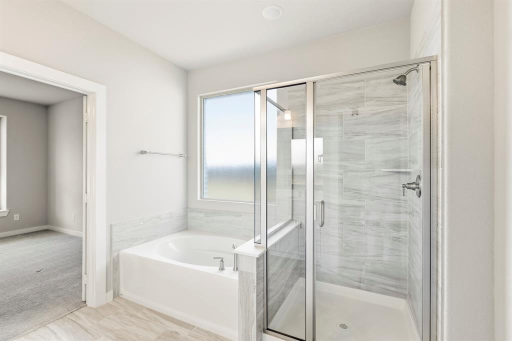 3311 Willena Road Melissa, TX 75454 - Photo 30 of 40 Bathroom featuring a glass-enclosed shower with tile surround, a built-in bathtub, a window, and light-toned tile flooring