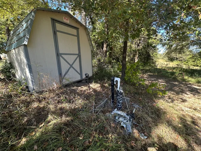 a backyard of a house with a table and chair