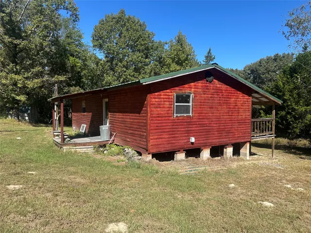 a view of a house with a yard and sitting area