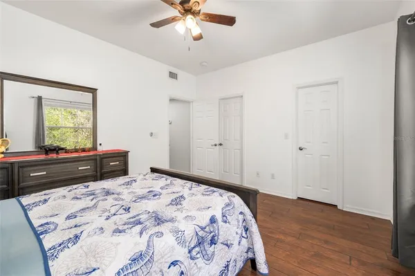 a bedroom with a bed and a dresser