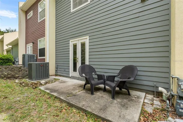 a backyard of a house with outdoor seating
