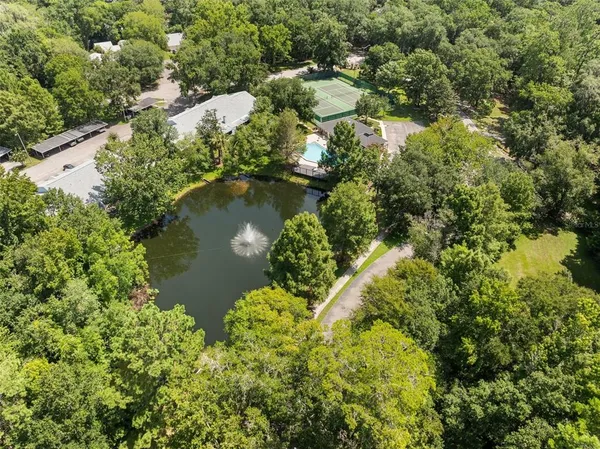 an aerial view of a house with a yard and lake view
