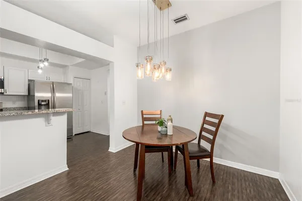 a view of a dining room with furniture and wooden floor