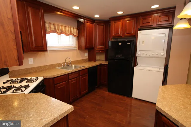 a kitchen with a refrigerator and a stove