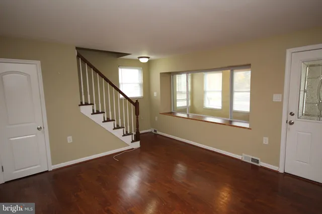 a view of an entryway with wooden floor and door