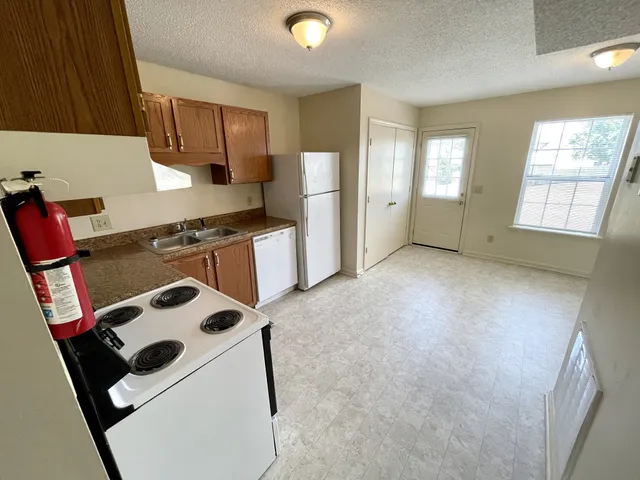 a view of kitchen and refrigerator