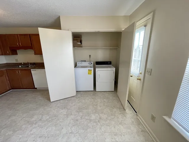 a kitchen with a refrigerator and a stove