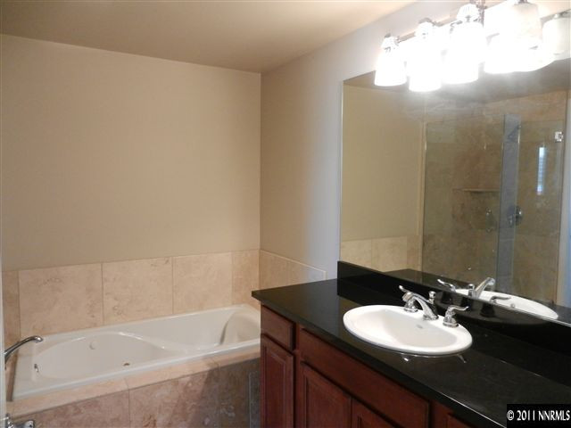 50 North Sierra Street, Unit 605 Reno, NV 89501 - Photo 11 of 11 a bathroom with a bathtub sink vanity and a mirror
