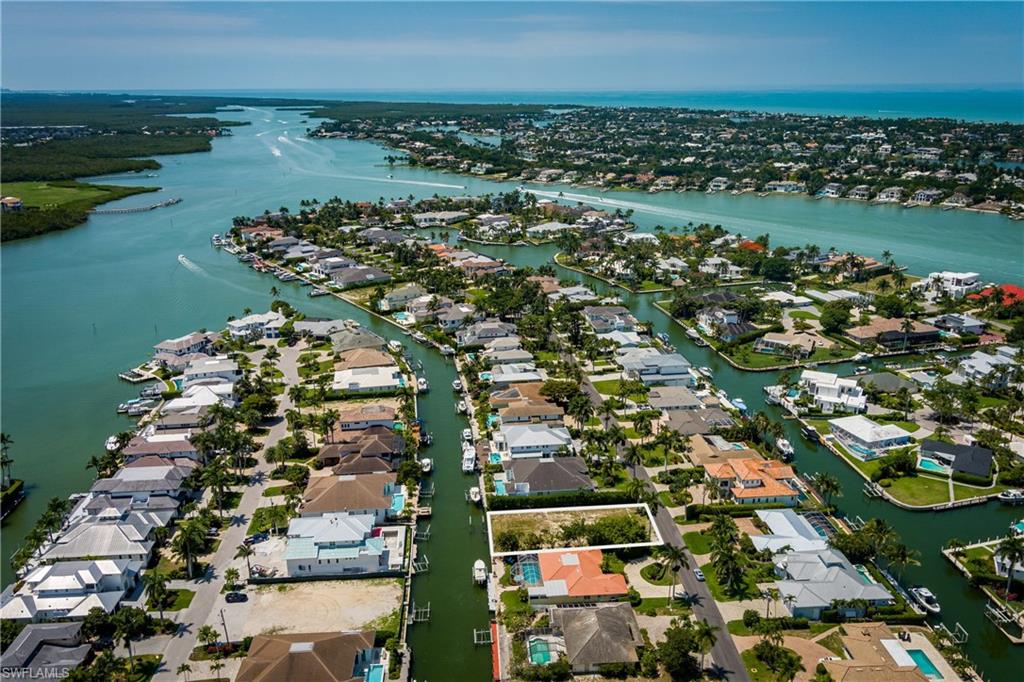 2165 Tarpon Road Naples, FL 34102 - Photo 1 of 24 an aerial view of a city with lots of residential buildings and ocean view in back
