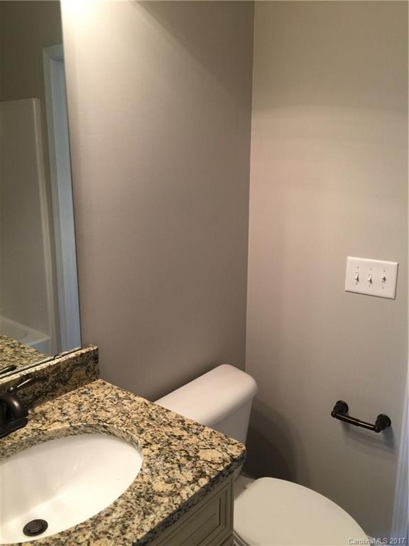 1854 State Rd S-46-168, Unit 4 York, SC 29745 - Photo 16 of 20 a bathroom with a granite countertop toilet and a sink